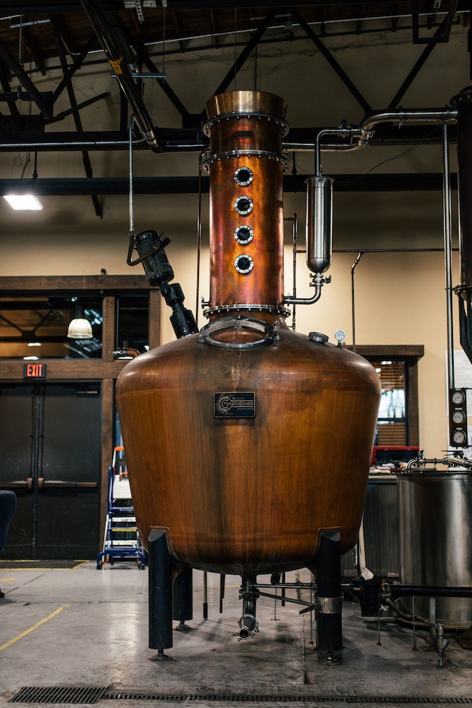 A distiller on the production floor of a spirits producer