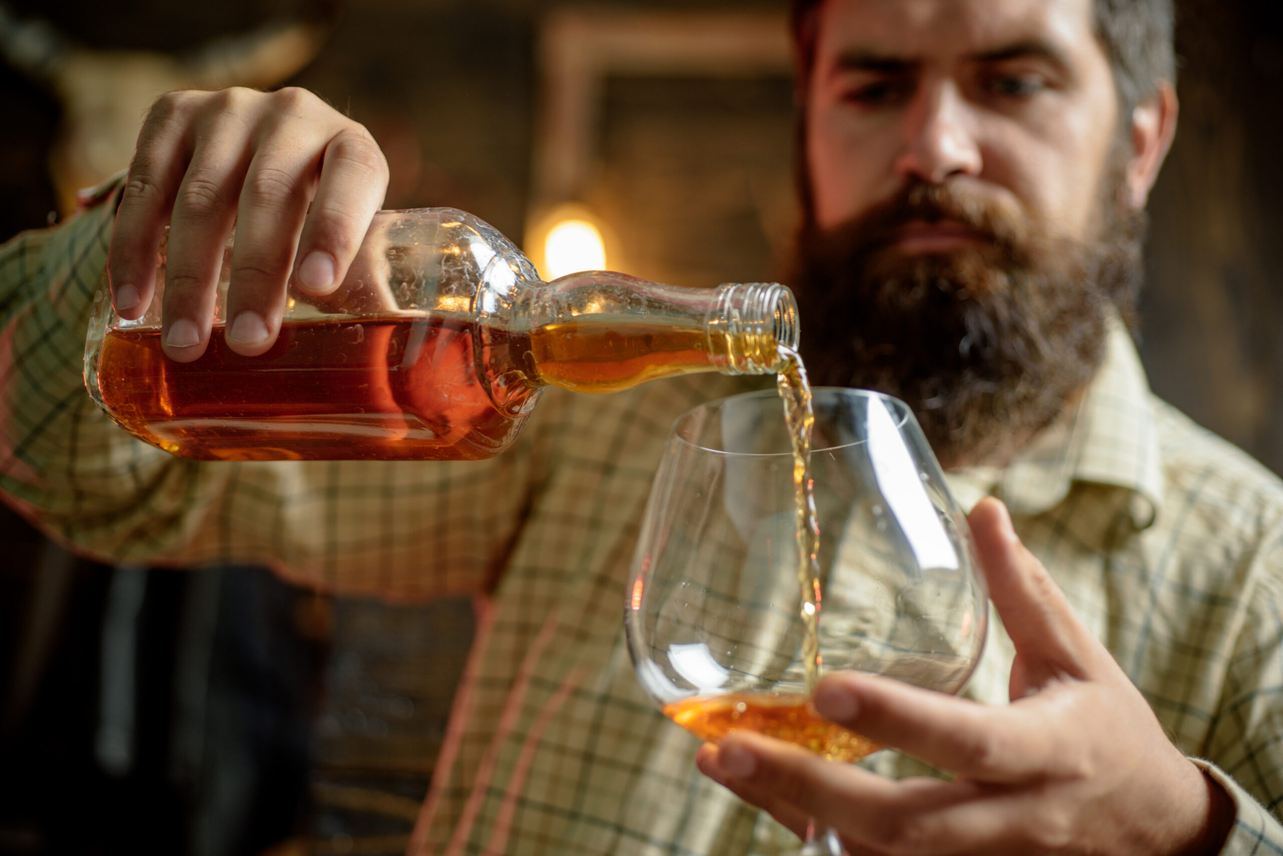 man pouring whiskey